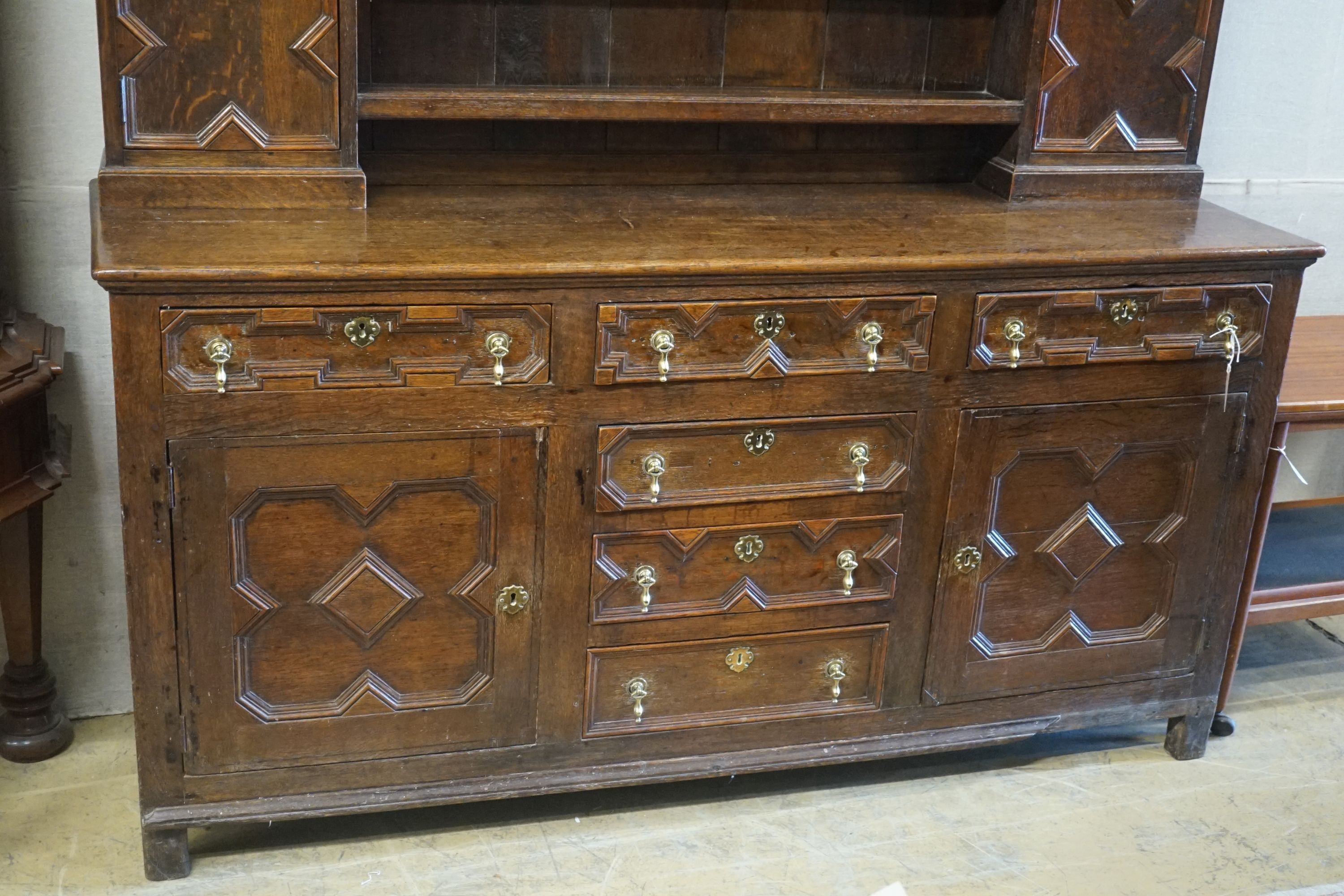 An 18th century oak dresser, length 180cm, depth 50cm, height 212cm